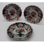A late 19th century Japanese porcelain dish, decorated with a flowering urn within a foliate border,