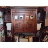 Vintage dresser cabinet with mirror panels and carved floral design to doors.