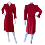 A 1940s day dress in red, with padded shoulders. Label reads Cohen Bros Style (1) 32 inch /82 cm