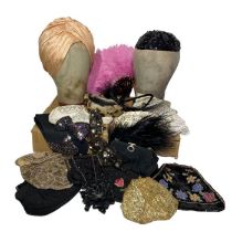 A collection of bags, a peach turban, sequinned skull cap, an interesting late 40s feather half hat,
