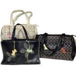Three top handled Radley leather handbags. One is in cream with a pierced and embroidered design-