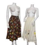 Two 1950s cotton novelty print skirts, one full circle with a Polynesian style print, and another