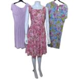 Vintage dresses in shades of pink and purple to include 2 1950s cotton day dresses, a 50s/60s floral