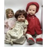 Large group of antique 25” pram Mannequin Baby doll in red wool pram coat set , an 18” tremble