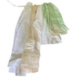 A group of lingerie to include a 1920s silk petticoat in green silk, a white cotton petticoat, white
