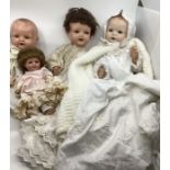 A 1930s group of Antique dolls and sprayed bisque dolls all baby toddler dolls in various pieces