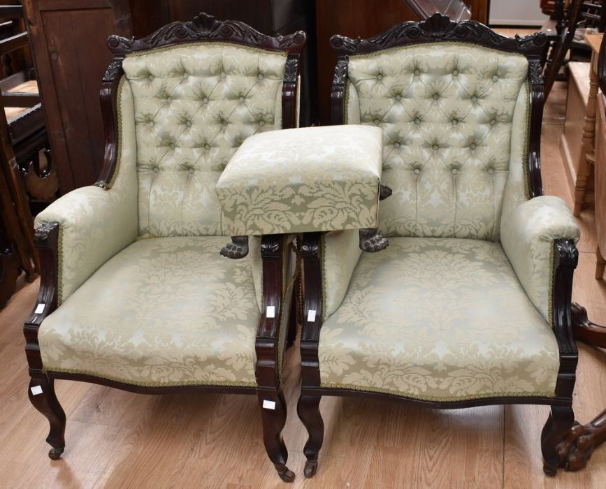 A pair of Victorian mahogany framed carved armchairs, scroll and shell top rail above upholstered