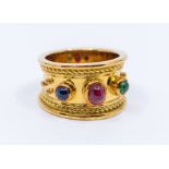 A ruby, sapphire and emerald set 18ct gold ring, circa 1992, comprising a central oval cabochon ruby