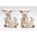 A pair of 19th century French porcelain mantel garnitures with hand-painted curved flutes and