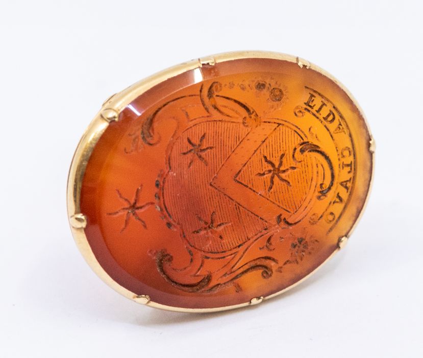 A 19th century carnelian and unmarked yellow metal (assessed as 18ct gold) seal fob, oval form