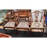 Pair of George III dining table armchairs with carved legs on ball-and-claw feet. The laddered backs