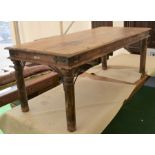 A Harwood Eastern dining table with cast supports, turned legs, plank top, rustic in style