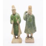 Two pottery funerary figures, Ming Dynasty, each standing on a square box, and their robes covered