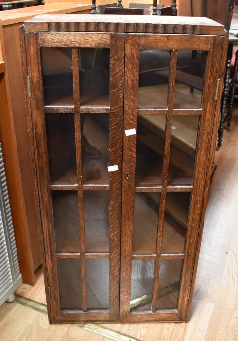 Two dark wood, early 20th century jardiniere stands, along with a small cabinet with glazed doors