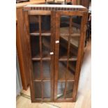 Two dark wood, early 20th century jardiniere stands, along with a small cabinet with glazed doors