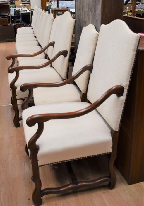 Fourteen hardwood continental-style dining chairs, including two carvers, with cream upholstery