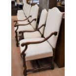 Fourteen hardwood continental-style dining chairs, including two carvers, with cream upholstery