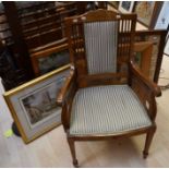 A mahogany Edwardian armchair, two fire screens, reproduction mirror framed tapestry and print
