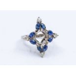 A sapphire and diamond 18ct white gold comprising a quatrefoil motif, with central round claw
