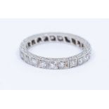 A diamond and 18ct white gold eternity ring, grain set with round brilliant cut diamonds, total