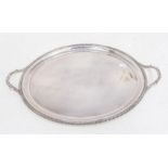 An Elizabeth II oval two handled silver tray, gadroon border and handles, plain reserve,