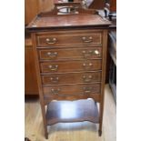 An Edwardian music cabinet with five drop-down drawers, inlaid decoration, on spear legs, with swing