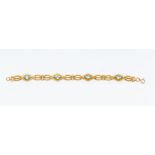 A blue topaz and 9ct gold bracelet, comprising alternate oval claw set blue topaz and gate style