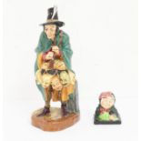 Two Royal Doulton items/figures; The Mask Seller and Dickens character