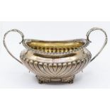 A George IV silver large two handled sugar basin, gadroon border, fluted body on foliate and paw