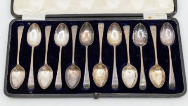 A set of twelve George V engraved Old English pattern teaspoons, hallmarked by Walter Trickett,
