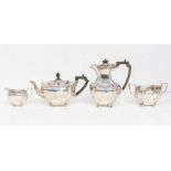 A George V silver four piece tea set, plain bodies with fluted corners, fruitwood handles and
