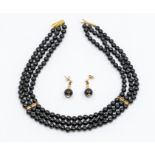 An onyx bead collar necklace, comprising three rows or round beads, each bead approx 5mm, with 9ct