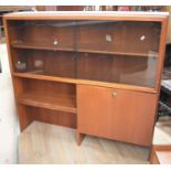 A 1970s teak glass-topped unit, 120 x 110cm, along with a large teak drop-leaf table