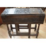 A late 19th century carved oak display cabinet with two carved glazed doors that open to reveal