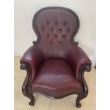 A large Victorian Gentleman's mahogany armchair with carved cabriole legs and arms large round top