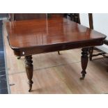 Large early Victorian wind-out table with three leaves and fluted legs on castors