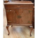 A mid-20th Century Chinese style drinks cabinet on splayed legs, having lift up lid to reveal mixing