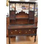 A George III small oak dresser on turned legs and with a plate rack, two single drawers to the