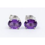 A pair of amethyst and silver stud earrings, comprising oval faceted amethysts  approx 5 x 7mm,