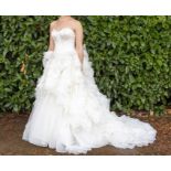 Vera Wang; wedding dress, very full skirt in tiers of tulle, the bodice is boned and strapless,