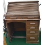 Early 20th Century tambour-fronted roll top desk, having four drawers, key present but appears not