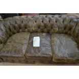 Faded brown 20th Century button-back three seater Chesterfield, worn condition, buttons missing,