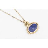 A 9ct gold double swivel set pendant comprising an oval lapis lazuli  and black lip oyster, scrolled