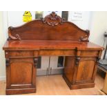 A large Victorian pedestal side board in mahogany, having central drawer with cupboard doors