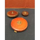Two early- to mid-20th century leather-cased vintage measuring tapes by Treble and Rabone, along