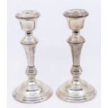 A pair of Elizabeth II silver candlesticks, reeded decoration, hallmarked by Barker & Co.,