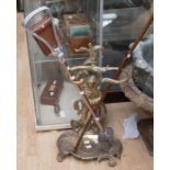 A French style ornate brass umbrella / stick stand, the support cast as a Gentleman standing over