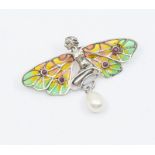 A silver and plique a jour enamel brooch in the form of a fairy, the wings with green, orange and