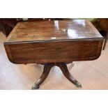 A Georgian mahogany Pembroke pedestal table on splayed legs with brass foliage-detailed castors,