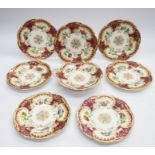 Seven 19th century porcelain decorative plates with matching cake stand, burgundy and gold with